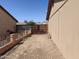 Side yard area featuring a gravel ground cover, fences, and a partial view of the neighboring houses at 6226 W Coronado Rd, Phoenix, AZ 85035