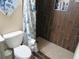 Modern bathroom features a tile shower with floral shower curtain and built-in shelving at 6226 W Coronado Rd, Phoenix, AZ 85035