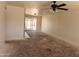 A spacious living room featuring a ceiling fan and sliding glass doors to the backyard at 6226 W Coronado Rd, Phoenix, AZ 85035