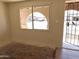 A bright living room showcases a window looking out to the front yard and street view at 6226 W Coronado Rd, Phoenix, AZ 85035