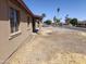 Side exterior view featuring simple landscaping, large windows, and a partial view of the street at 6226 W Coronado Rd, Phoenix, AZ 85035