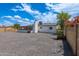 Home exterior featuring a chimney, white paint, block walls, and a gravel backyard at 6316 N 23Rd Ave, Phoenix, AZ 85015