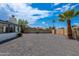Spacious backyard featuring a gravel yard, block perimeter wall, and mature trees at 6316 N 23Rd Ave, Phoenix, AZ 85015