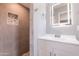 Bathroom featuring a modern vanity, lighted mirror, and tiled shower at 6316 N 23Rd Ave, Phoenix, AZ 85015
