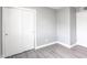 Cozy bedroom with light wood floors, sliding closet doors, and grey walls at 6316 N 23Rd Ave, Phoenix, AZ 85015