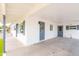 A covered carport featuring white brick, fresh paint, and a front door with charming windows at 6316 N 23Rd Ave, Phoenix, AZ 85015