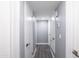 Bright hallway featuring clean white doors and modern hardware with light grey wall paint at 6316 N 23Rd Ave, Phoenix, AZ 85015