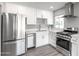 Modern kitchen with stainless steel appliances, white cabinets, and countertops providing a sleek and functional space at 6316 N 23Rd Ave, Phoenix, AZ 85015