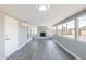Bright living room featuring luxury vinyl plank flooring, a stone fireplace, and abundant natural light at 6316 N 23Rd Ave, Phoenix, AZ 85015