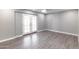 Spacious living room featuring vinyl plank flooring, neutral paint, and double doors to the yard at 6316 N 23Rd Ave, Phoenix, AZ 85015