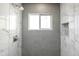 Newly renovated shower with bright gray and white tile and built-in shelf at 6316 N 23Rd Ave, Phoenix, AZ 85015