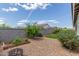 Low maintenance backyard with gravel landscaping, a raised garden bed, and a fire pit at 686 N 152Nd Dr, Goodyear, AZ 85338