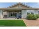 Relaxing backyard patio with a grill, seating area, and sliding glass doors for indoor-outdoor living at 686 N 152Nd Dr, Goodyear, AZ 85338
