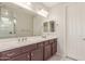 Bathroom with a double sink vanity, a large mirror, and a shower with glass doors at 686 N 152Nd Dr, Goodyear, AZ 85338