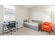 Bedroom featuring neutral carpet and walls with a day bed, desk and orange accent chair at 686 N 152Nd Dr, Goodyear, AZ 85338