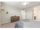 Inviting bedroom with neutral walls, a wooden dresser, and bright natural light for a relaxing atmosphere at 686 N 152Nd Dr, Goodyear, AZ 85338