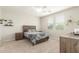 Cozy bedroom featuring a rustic wood bed frame, natural light, and neutral color palette at 686 N 152Nd Dr, Goodyear, AZ 85338
