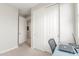 Bright bedroom featuring closet, neutral walls, carpet, and a desk with laptop and lamp at 686 N 152Nd Dr, Goodyear, AZ 85338