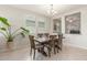 Elegant dining room with a spacious wooden table, stylish chandelier, and bright natural light at 686 N 152Nd Dr, Goodyear, AZ 85338