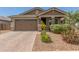 Charming single-story home features a brick driveway, two-car garage, and a beautifully landscaped front yard at 686 N 152Nd Dr, Goodyear, AZ 85338