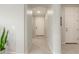 Bright hallway with neutral tones, tiled flooring, and an arched entrance leading to the main living spaces at 686 N 152Nd Dr, Goodyear, AZ 85338