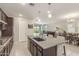 Open-concept kitchen with granite counters, island seating, and views of the living and dining areas at 686 N 152Nd Dr, Goodyear, AZ 85338