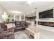 Inviting living room boasts an electric fireplace, large-screen TV, and seamless flow into the kitchen and dining area at 686 N 152Nd Dr, Goodyear, AZ 85338
