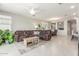 Comfortable living room with plush seating, a ceiling fan, and views into the dining and kitchen areas at 686 N 152Nd Dr, Goodyear, AZ 85338