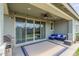 Covered patio with seating and fan overlooks the spacious backyard, perfect for outdoor relaxation at 686 N 152Nd Dr, Goodyear, AZ 85338