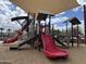 Community playground featuring play structures for children with shading for sun protection at 686 N 152Nd Dr, Goodyear, AZ 85338