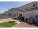 Backyard featuring artificial turf, seating area, and grill, perfect for outdoor entertaining at 7028 W Lincoln St, Peoria, AZ 85345