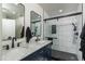 Modern bathroom featuring a double vanity and a stylishly tiled shower at 7028 W Lincoln St, Peoria, AZ 85345