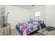 Comfortable bedroom with a large window, desk setup, and simple decor for a cozy atmosphere at 7028 W Lincoln St, Peoria, AZ 85345