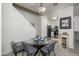 Cozy dining area adjacent to kitchen, with a glass table and stairway at 7028 W Lincoln St, Peoria, AZ 85345