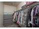 Spacious walk-in closet with ample clothing rods and shelving units for storage and organization at 7028 W Lincoln St, Peoria, AZ 85345