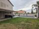 Backyard featuring a large pool, covered patio with seating, and green lawn at 7240 W Los Gatos Dr, Glendale, AZ 85310