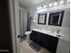 Modern bathroom with double sinks, sleek black vanities, and updated fixtures at 7240 W Los Gatos Dr, Glendale, AZ 85310