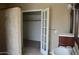 Bathroom featuring double doors to walk-in closet, vanity with sink, and stone shower at 7240 W Los Gatos Dr, Glendale, AZ 85310