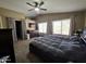 Spacious bedroom with ceiling fan, large windows, closet, and comfortable king size bed at 7240 W Los Gatos Dr, Glendale, AZ 85310