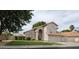 Inviting single Gathering home with neutral stucco exterior and tile roof and manicured green lawn at 7240 W Los Gatos Dr, Glendale, AZ 85310