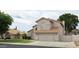 Charming home featuring a well-maintained lawn and a neutral stucco facade with a tile roof at 7240 W Los Gatos Dr, Glendale, AZ 85310