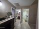 Hallway leading to a bathroom and laundry room, complete with elegant furnishings at 7240 W Los Gatos Dr, Glendale, AZ 85310