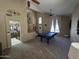 Spacious living room with stairs, large windows, open floor plan, and ceiling fan at 7240 W Los Gatos Dr, Glendale, AZ 85310