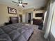 Spacious primary bedroom boasts a ceiling fan, plush carpet, and ample closet space at 7240 W Los Gatos Dr, Glendale, AZ 85310
