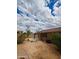 Spacious backyard with a covered patio, offering potential for outdoor entertaining and relaxation, and desert landscaping at 7310 W Pioneer St, Phoenix, AZ 85043