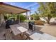 Enjoy outdoor living on the covered patio with a grill and picnic table in a private backyard at 7608 E Avalon Dr, Scottsdale, AZ 85251