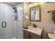Bathroom featuring a tiled glass shower, updated fixtures, and wood-look vanity at 7608 E Avalon Dr, Scottsdale, AZ 85251