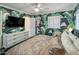 Primary bedroom showcasing tropical wallpaper, a flat screen TV, and bright natural light at 7608 E Avalon Dr, Scottsdale, AZ 85251
