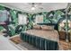 Stylish bedroom with a king bed, tropical wallpaper, and bright natural light from two shuttered windows at 7608 E Avalon Dr, Scottsdale, AZ 85251