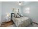 Brightly lit bedroom featuring a queen bed, natural light, and light blue walls at 7608 E Avalon Dr, Scottsdale, AZ 85251
